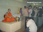 Worshiping the monk while the monk pours the holy water
